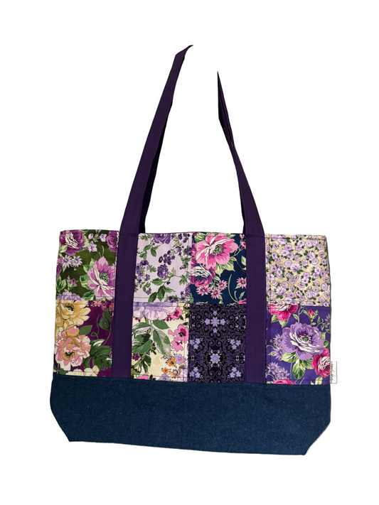 Floral patterned tote bag with purple handles.